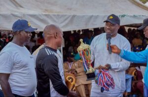 Hon (Pharmacist) Ahmed Baba Yahaya, Immediate past Nasarawa State Commissioner for Health presenting a trophy to a team 