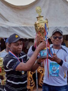 Executive Chairman Toto LGC ably represented by his Deputy, Alhaji Abubakar Haruna Kwanakis being supported while presenting a trophy to one of the team. 