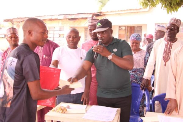 Member representing Akwanga North constituency at the Nasarawa State House of Assembly, Hon Larry Ven Bawa presenting scholarship grant one of the beneficiaries