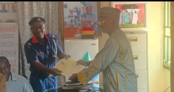 R-L: Toto LGC Executive Chairman, Hon Aliyu Abdullahi Tashas presenting C of O to OC in charge of NSCDC for Toto LGA