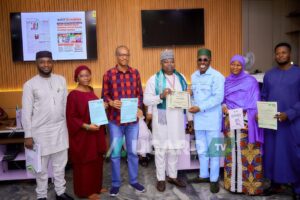 Prince Salih Musa Yakubu, Executive Director of the Centre presenting an award to the Special Adviser to the Governor on Media, Hon. Ismaila Isah and other recipients